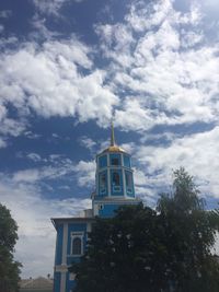 Low angle view of building and trees against sky