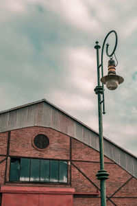 Low angle view of street light against building