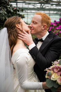 Bride and bridegroom holding bouquet