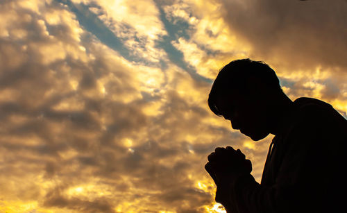 Low angle view of silhouette man against sky during sunset