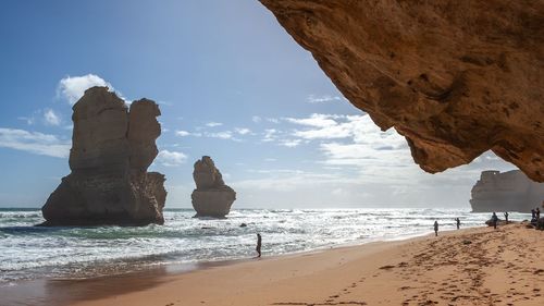 Scenic view of rocks on beach against sky