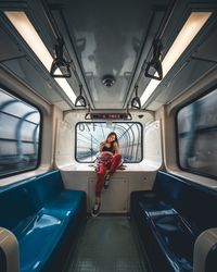 Portrait of woman sitting in train