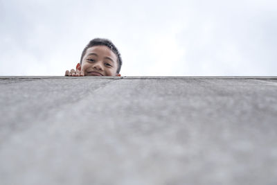 Low angle view portrait of girl against sky