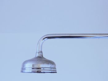 Close-up of glass bottle against blue background