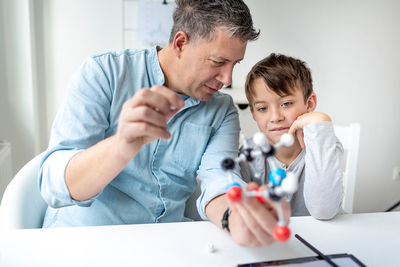 Father and son with toy at home