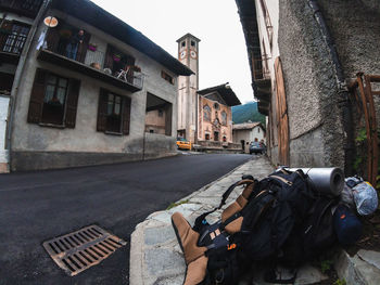 Man photographing on road by buildings in city