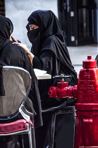 Midsection of man with umbrella