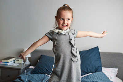 Portrait of smiling girl sitting at home