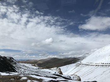 Scenic view of snow covered mountains against sky