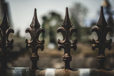 Low angle view of carvings on metal fence at temple