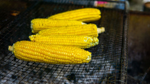 High angle view of yellow meat on barbecue grill