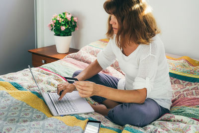 Woman using laptop at home