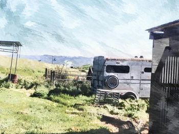 Abandoned truck on field against sky