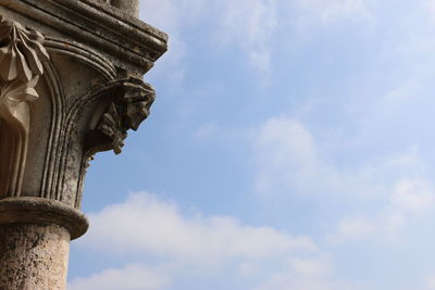 Low angle view of historic building against cloudy sky