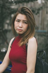 Portrait of worried young woman standing in city