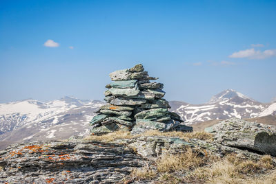 Stack of rock against sky during winter
