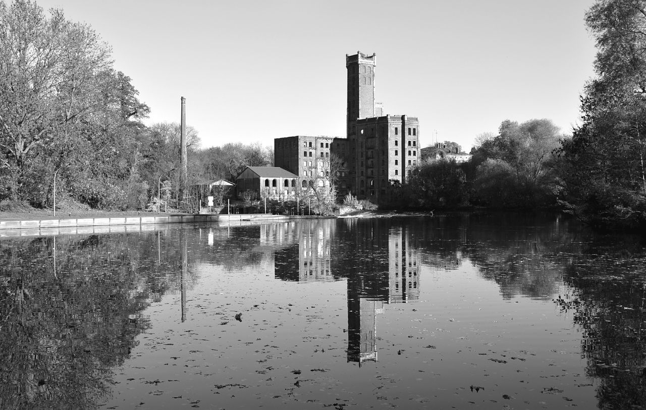 water, tree, built structure, reflection, architecture, clear sky, building exterior, lake, river, waterfront, sky, day, tranquility, nature, outdoors, no people, tranquil scene, canal, railing, house