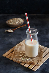 High angle view of oat flake with milk against black background