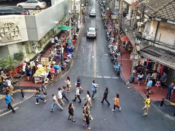 High angle view of people walking on road in city