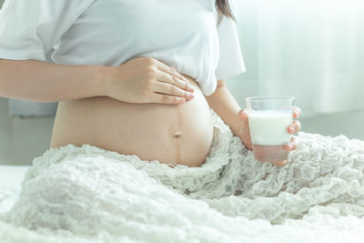 Midsection of woman holding ice cream