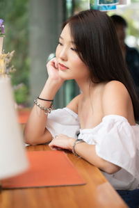 Young woman sitting on table