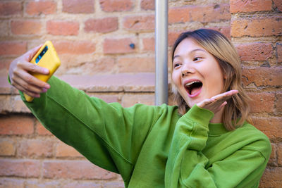 Young woman holding mobile phone