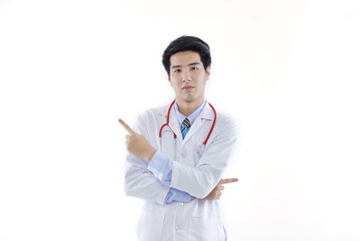 Mid adult man standing against white background