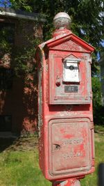 Close-up of red mailbox on tree