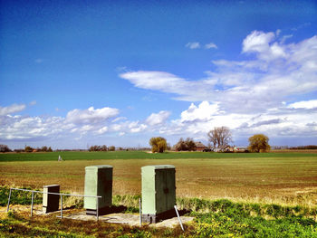 Scenic view of field against cloudy sky