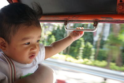 Close-up of cute baby boy in bus