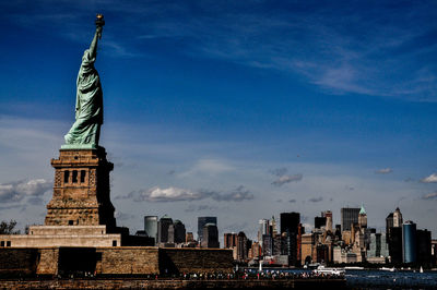 Statue of modern building against sky