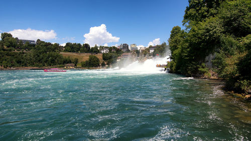 Scenic view of waterfall against sky