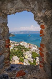 Scenic view of sea by town against sky