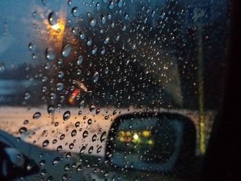 Close-up of wet car window in rainy season