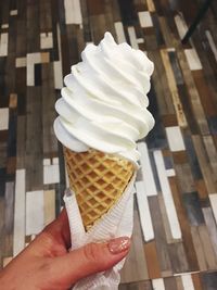 Close-up of hand holding ice cream cone