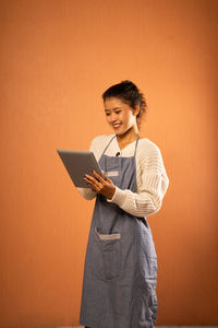 Portrait of young woman using digital tablet