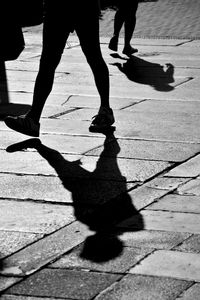 Low section of people walking on street