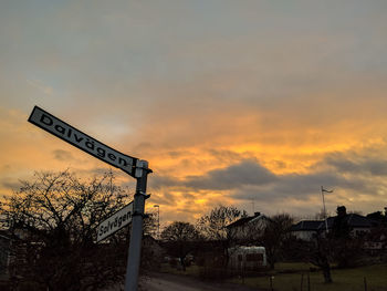 Low angle view of silhouette building against dramatic sky