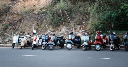 Motor scooters parked on road
