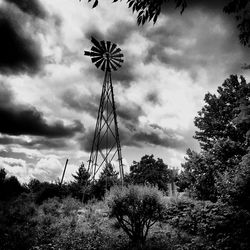 Low angle view of windmill against cloudy sky