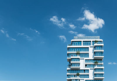 Low angle view of modern apartment building against sky