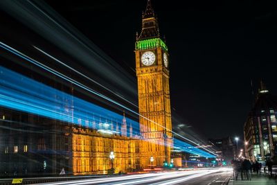 Light trails against clock tower