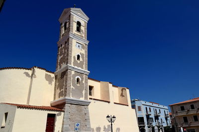 Low angle view of historic building against clear blue sky