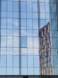 Low angle view of glass building in city