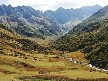 Scenic view of valley and mountains against sky