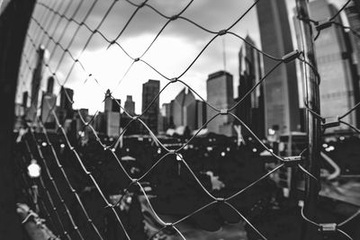 Close-up of chainlink fence against sky