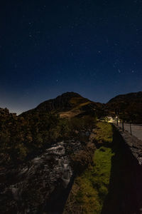 Scenic view of mountains against sky at night