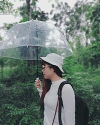 Young woman holding umbrella