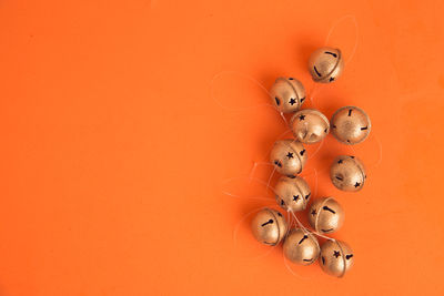 Directly above shot of small bells on orange background