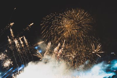 Low angle view of firework display at night